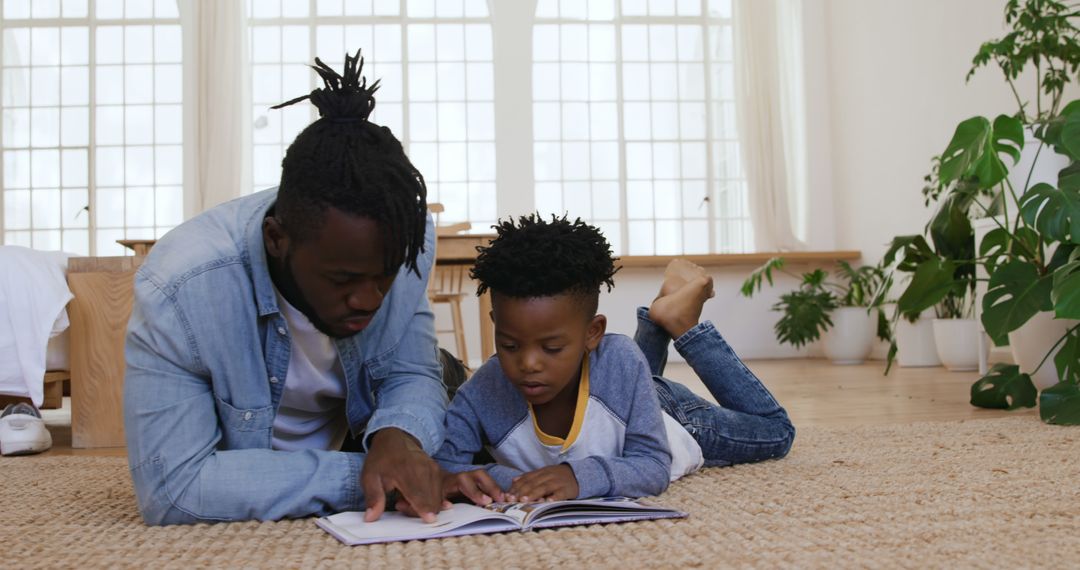 Father and Son Reading Book Together at Home - Free Images, Stock Photos and Pictures on Pikwizard.com