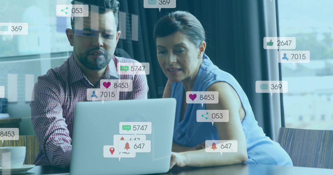 Colleagues Analyzing Social Media Metrics on Laptop Screen