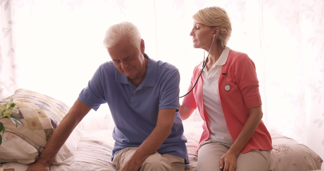 Elderly Man Receiving Home Healthcare from Nurse with Stethoscope - Free Images, Stock Photos and Pictures on Pikwizard.com