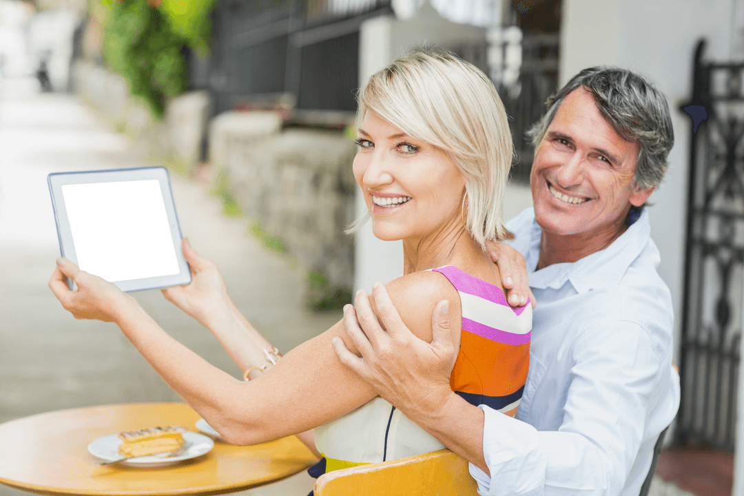 Transparent Smiling Couple Exploring Digital Tablet Outdoors