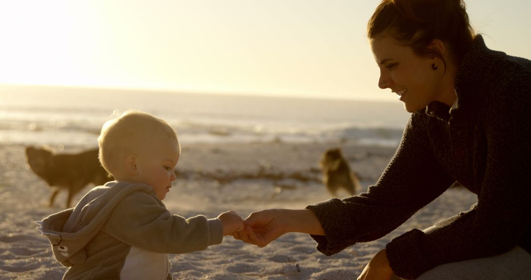 Mother and Baby Holding Hands at Beach Sunset - Free Images, Stock Photos and Pictures on Pikwizard.com