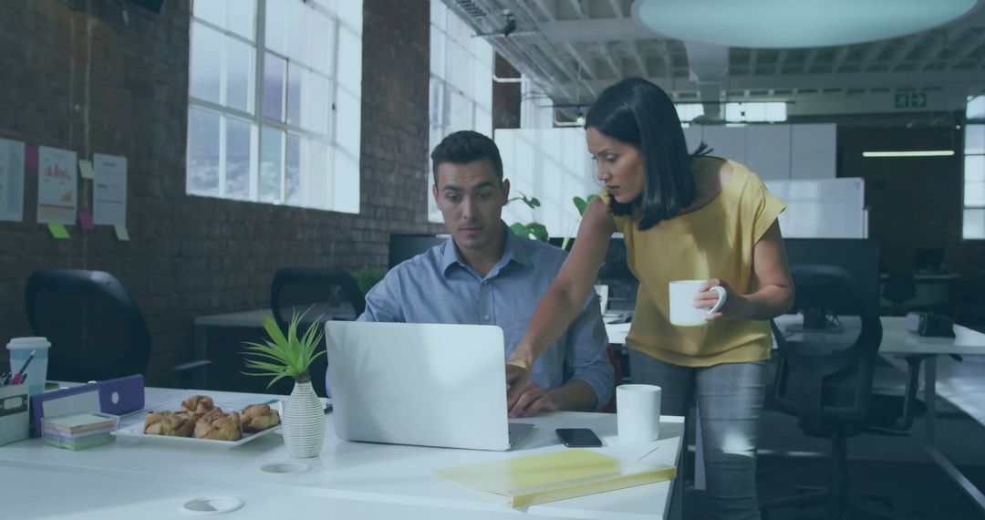 Team Members Collaborating on Project in Modern Office Setting