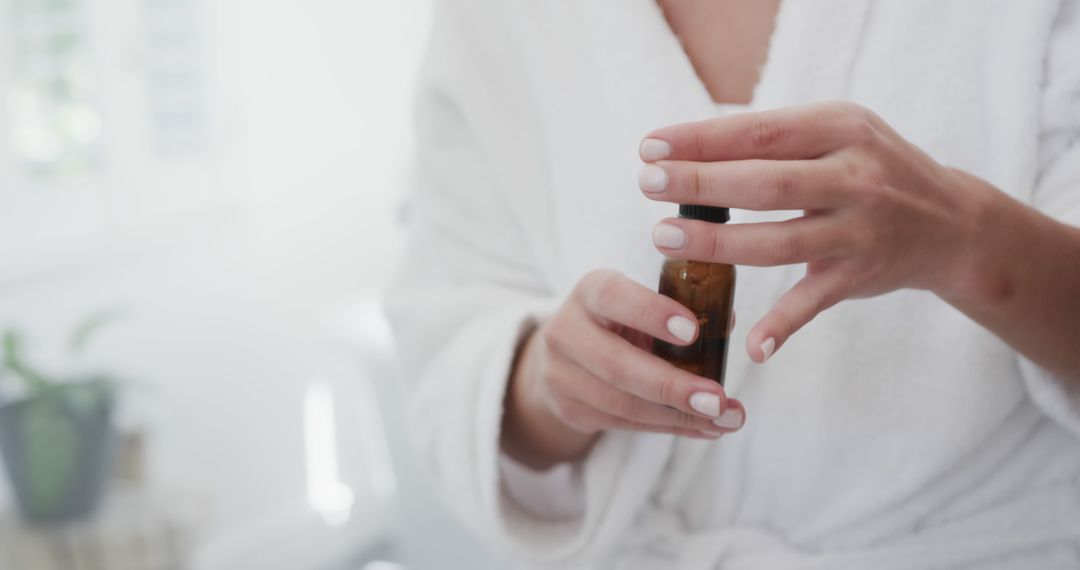 Woman Applying Serum in Bathroom, Self-Care Routine - Free Images, Stock Photos and Pictures on Pikwizard.com