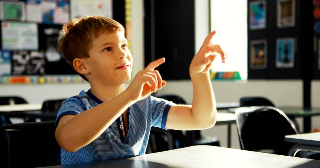 Young Boy Raising Hand in Classroom During Lesson - Free Images, Stock Photos and Pictures on Pikwizard.com