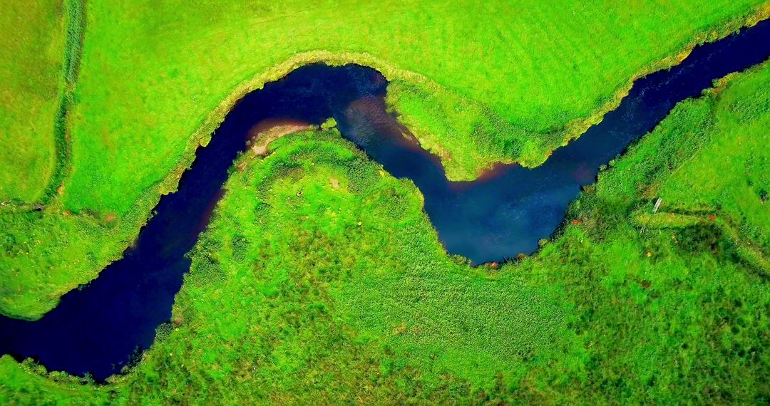 Aerial View of Meandering River in Lush Green Landscape - Free Images, Stock Photos and Pictures on Pikwizard.com