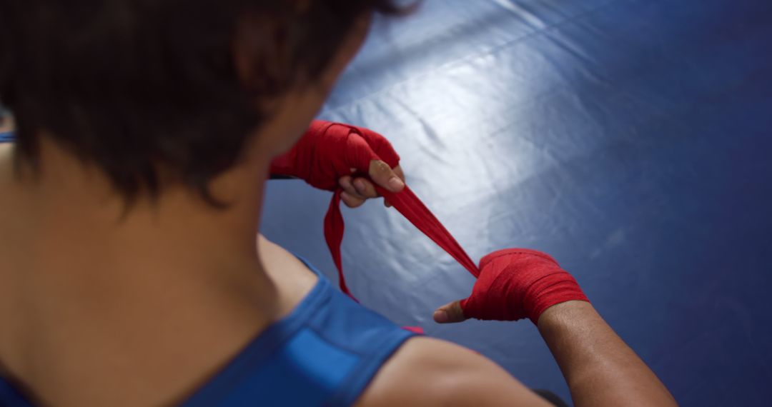 Amateur Boxer Wrapping Hands with Red Bandages - Free Images, Stock Photos and Pictures on Pikwizard.com