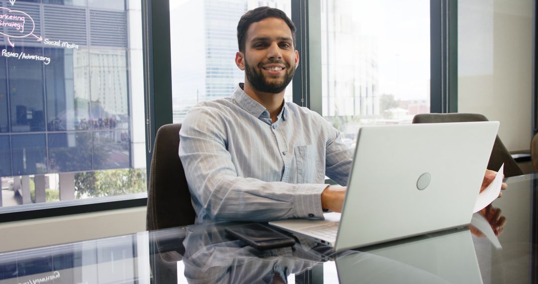 Young Professional Man Working on Laptop in Office Environment
