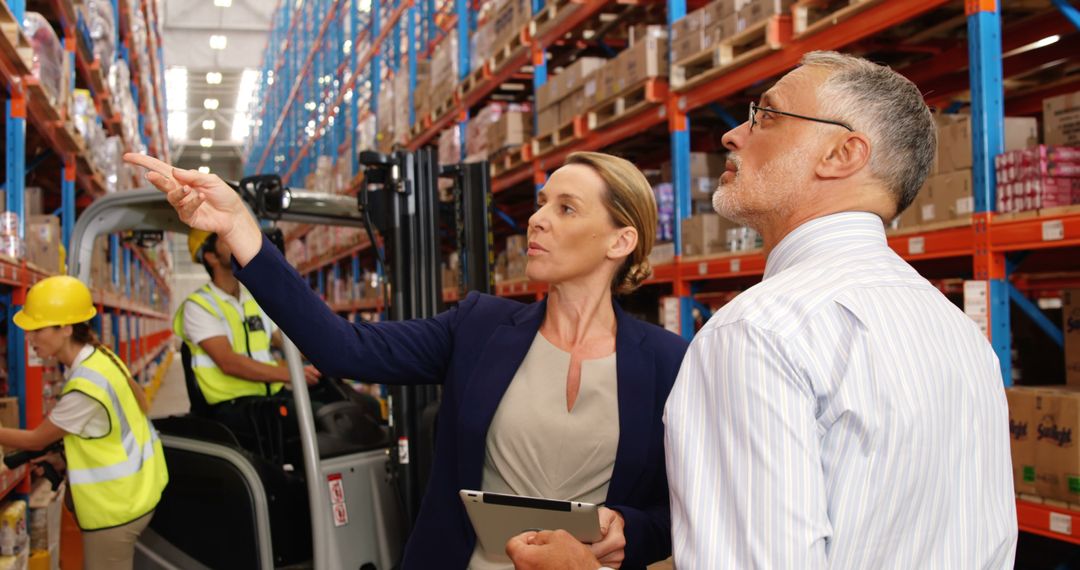 Manager Supervising Warehouse Operations with Digital Tablet