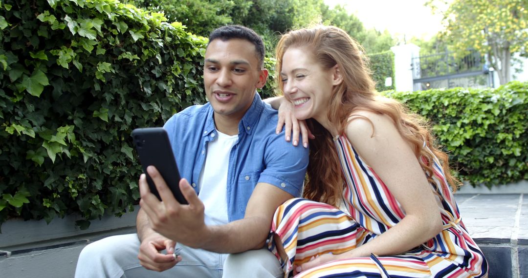 Couple Sharing Happy News Via Video Call on Front Steps