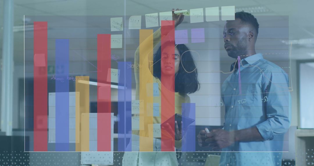 Colleagues Collaborating with Data Visuals in Modern Office