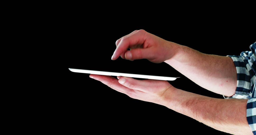 Hands Holding Tablet and Using Touchscreen Isolated on Black Background - Free Images, Stock Photos and Pictures on Pikwizard.com