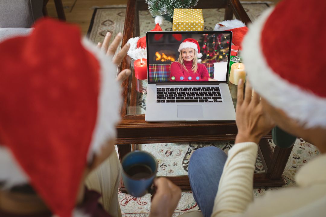 Diverse couple with santa hats having video call with happy caucasian woman - Free Images, Stock Photos and Pictures on Pikwizard.com