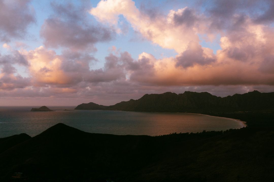 Sunset Over Serene Mountain Range by the Ocean