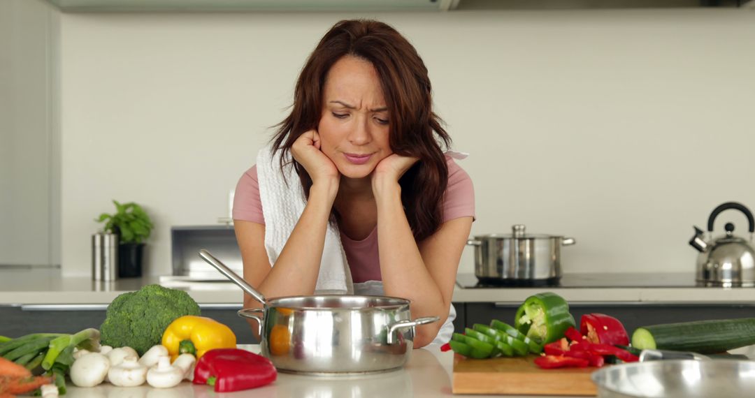 Frustrated Woman Cooking in Modern Kitchen Feeling Stressed - Free Images, Stock Photos and Pictures on Pikwizard.com