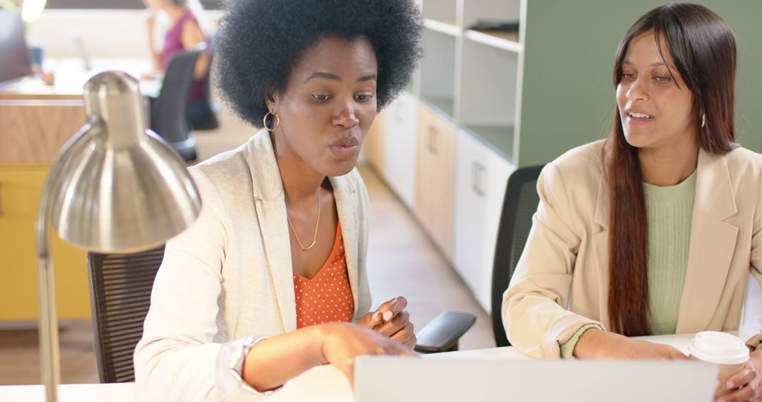 Diverse Businesswomen Discussing Ideas Using Laptop in Office