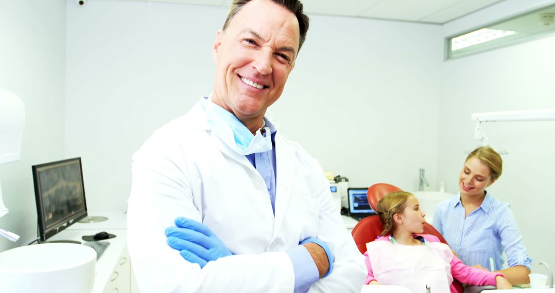 Smiling Dentist with Young Patient Receiving Treatment - Free Images, Stock Photos and Pictures on Pikwizard.com