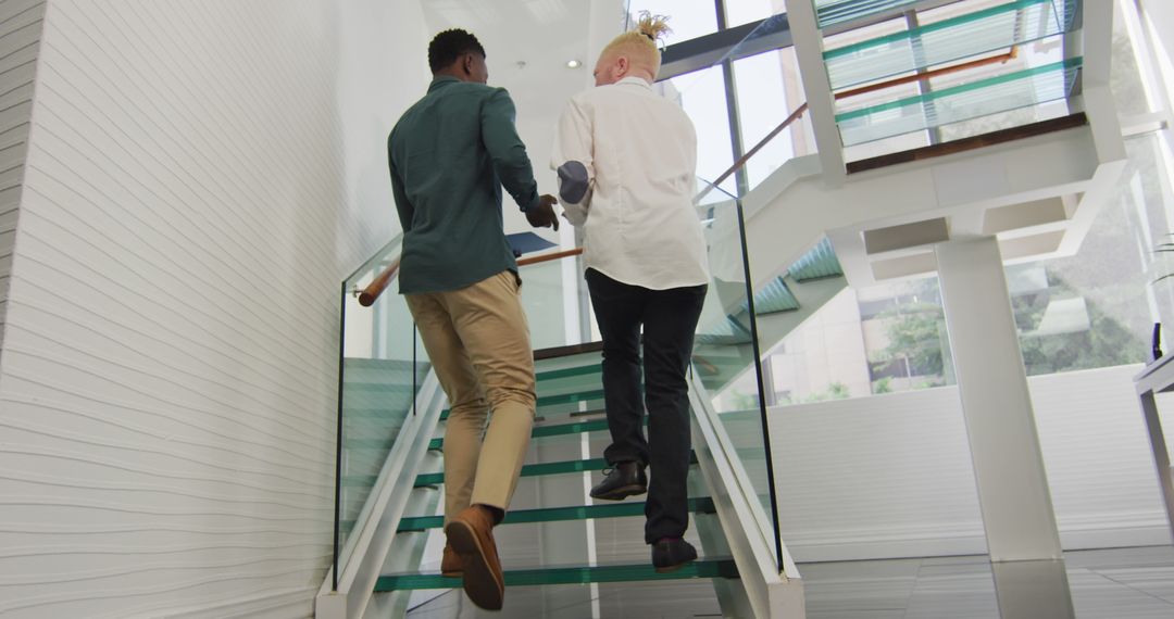 Diverse Businessmen Climbing Stairs in Modern Office Building - Free Images, Stock Photos and Pictures on Pikwizard.com