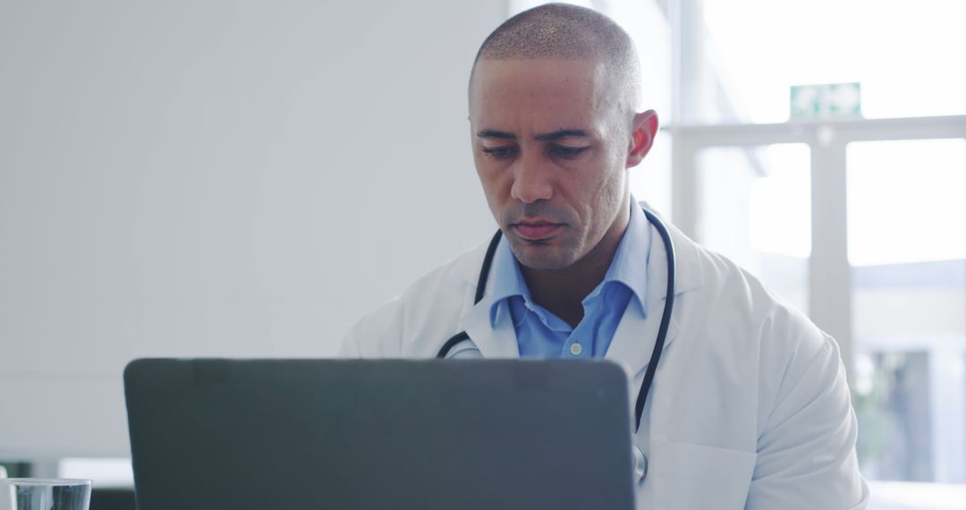 Focused Male Doctor Using Computer in Office - Free Images, Stock Photos and Pictures on Pikwizard.com