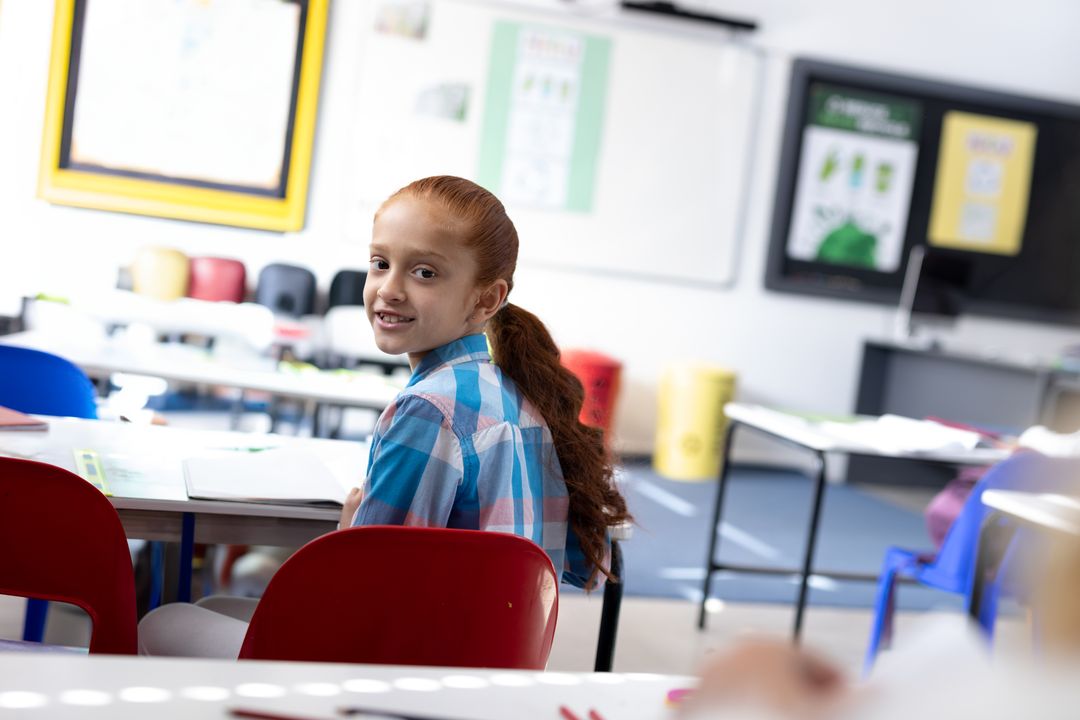 Smiling Schoolgirl Turning Back in Colorful Classroom