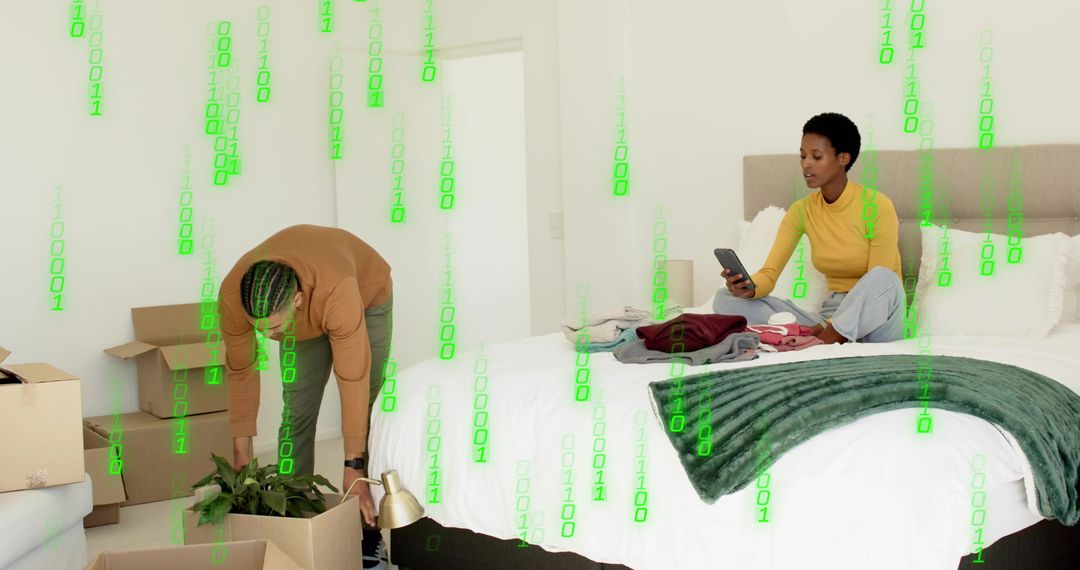 Young couple unpacking in modern minimalist bedroom, using smartphone and arranging plants