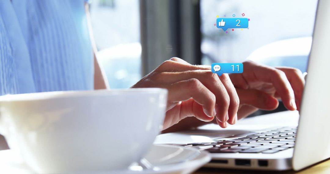 Hands Typing on Laptop with Social Media Likes and Comments