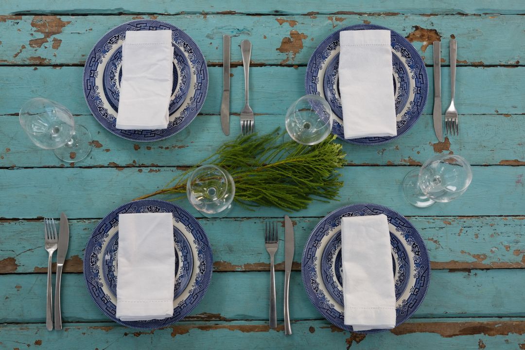 Rustic Table Setting with Blue Plates on Weathered Wooden Plank - Free Images, Stock Photos and Pictures on Pikwizard.com