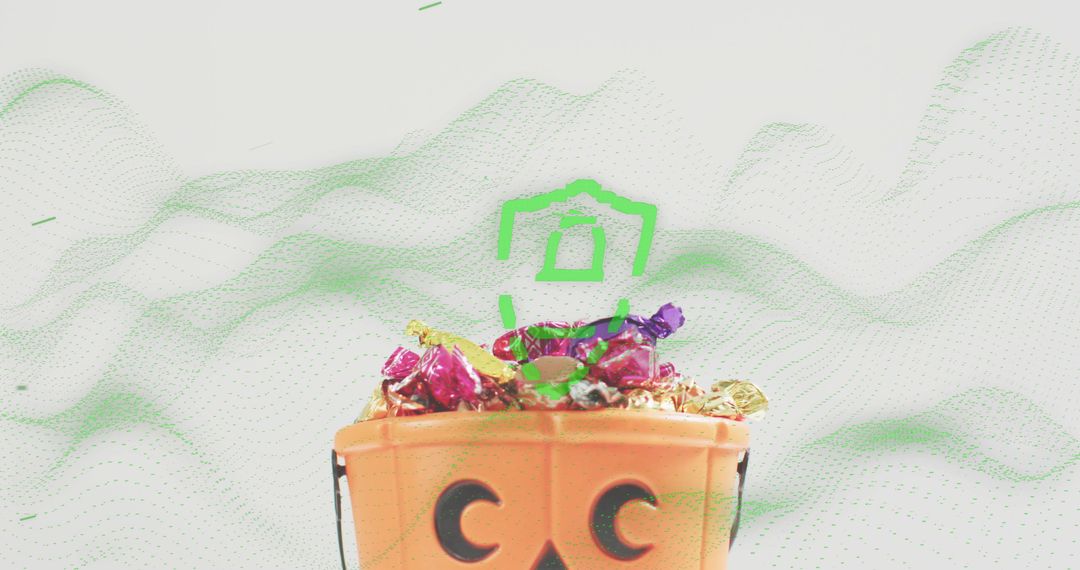 Jack-o-lantern candy bucket overflowing with colorful wrapped sweets and metallic foil