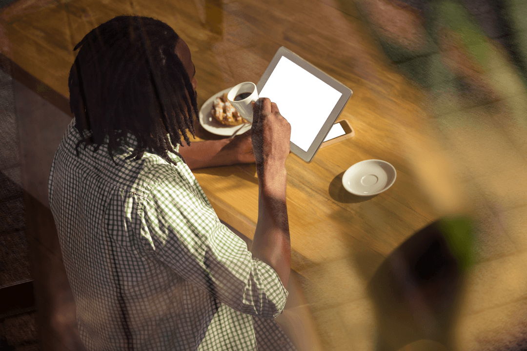 Man Using Transparent Digital Tablet Drinking Coffee