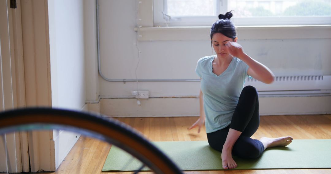 Woman Practicing Indoor Yoga for Flexibility and Wellbeing - Free Images, Stock Photos and Pictures on Pikwizard.com