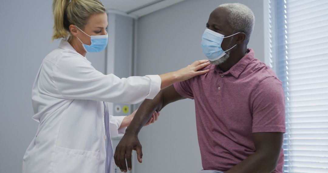 Doctor Examining Senior Patient with Face Masks in Medical Clinic - Free Images, Stock Photos and Pictures on Pikwizard.com