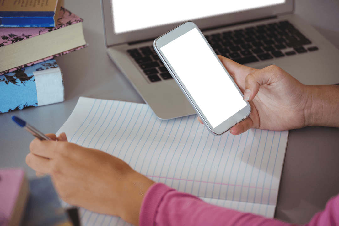 Transparent smartphone in schoolgirl's hands at library desk