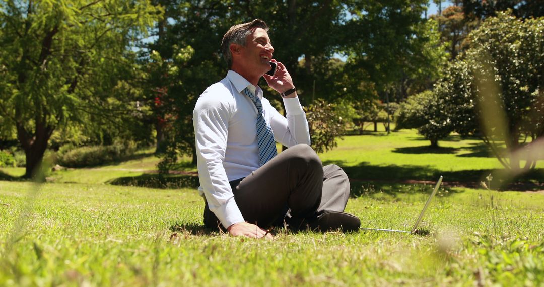 Businessman Working Remotely Outdoors on Sunny Day - Free Images, Stock Photos and Pictures on Pikwizard.com