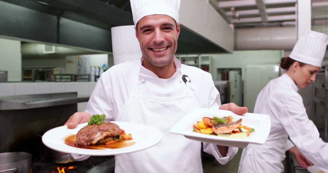 Smiling Chef Presenting Dishes in Restaurant Kitchen - Free Images, Stock Photos and Pictures on Pikwizard.com