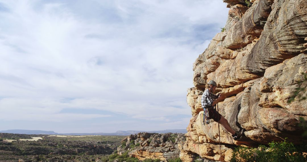 Male Rock Climber Traversing Rocky Cliff - Free Images, Stock Photos and Pictures on Pikwizard.com