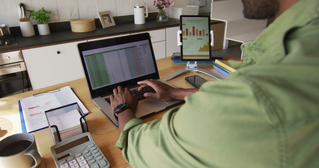 Businessman Analyzing Data on Laptop and Digital Tablet in Home Office - Free Images, Stock Photos and Pictures on Pikwizard.com