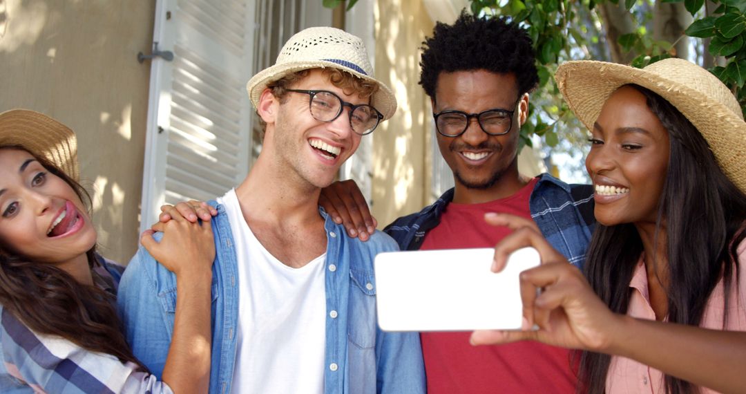 Diverse Friends Smiling and Taking Selfie Outdoors on Sunny Day