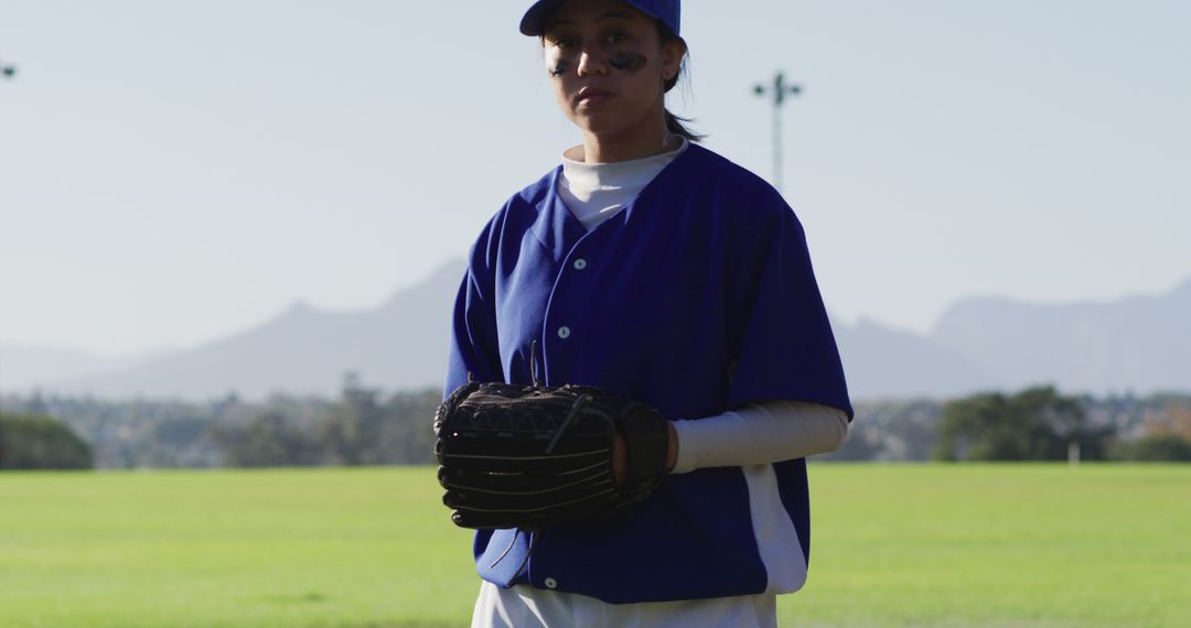 Female Baseball Player Standing on Field in Blue and White Uniform - Free Images, Stock Photos and Pictures on Pikwizard.com