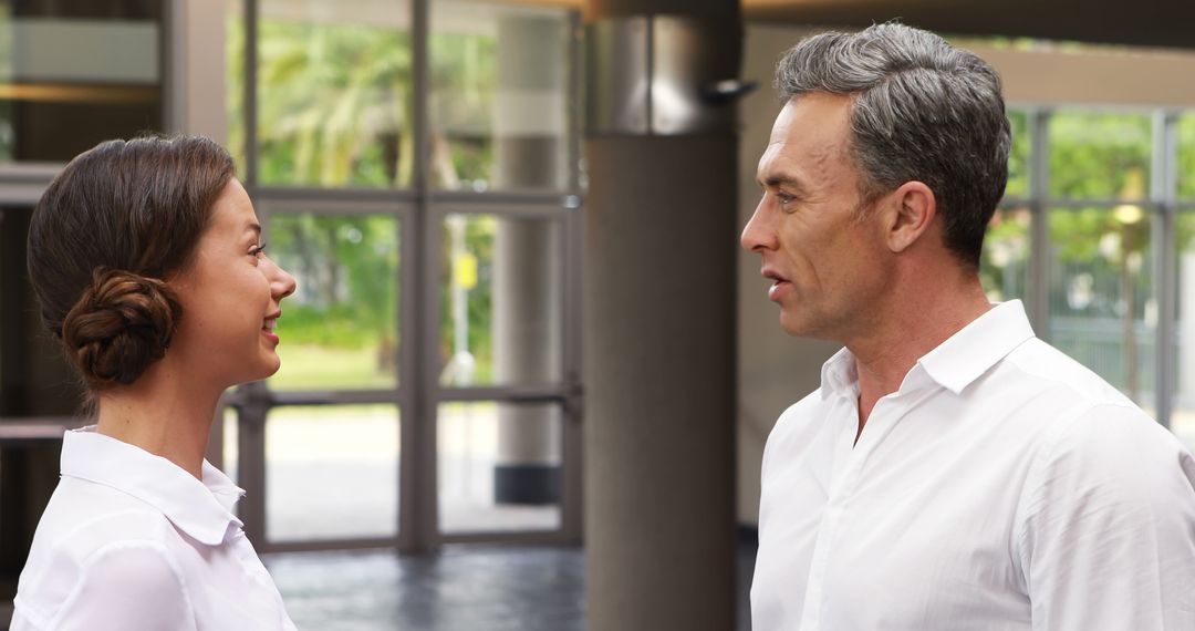 Colleagues Engaged in Office Conversation with Copy Space