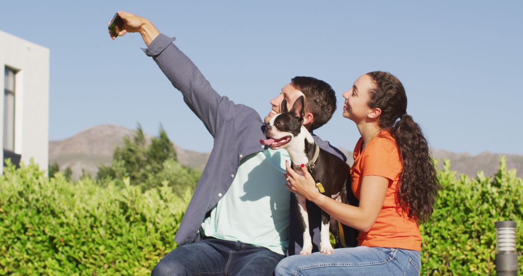 Couple Taking Selfie with Dog in Sunny Garden
