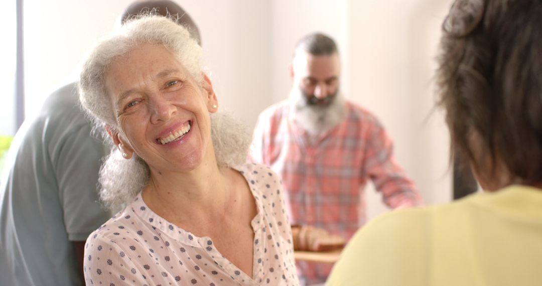 Joyful Senior Woman Smiling at Social Gathering