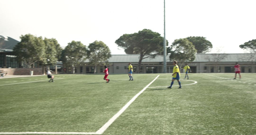 Soccer Players Competing with Teamwork on Green Field