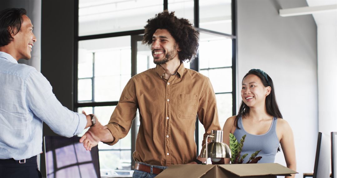 Diverse Team Greeting with Handshake in Modern Office Setting