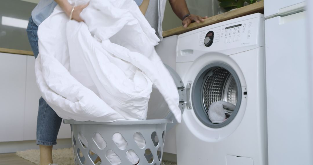 Couple Doing Laundry at Home with Washing Machine
