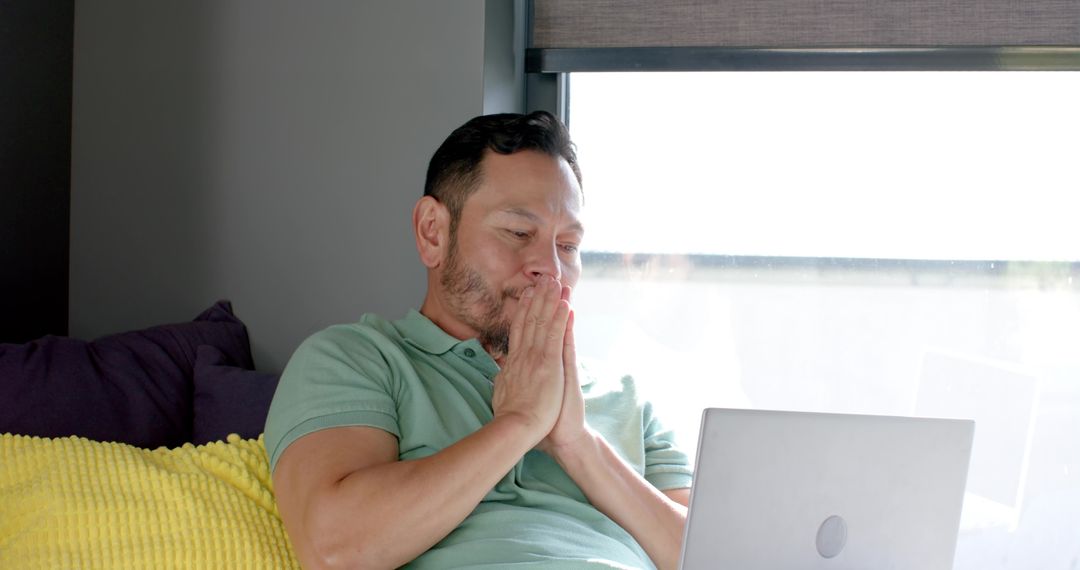 Thoughtful Man Relaxing with Laptop, Contemporary Home Setting