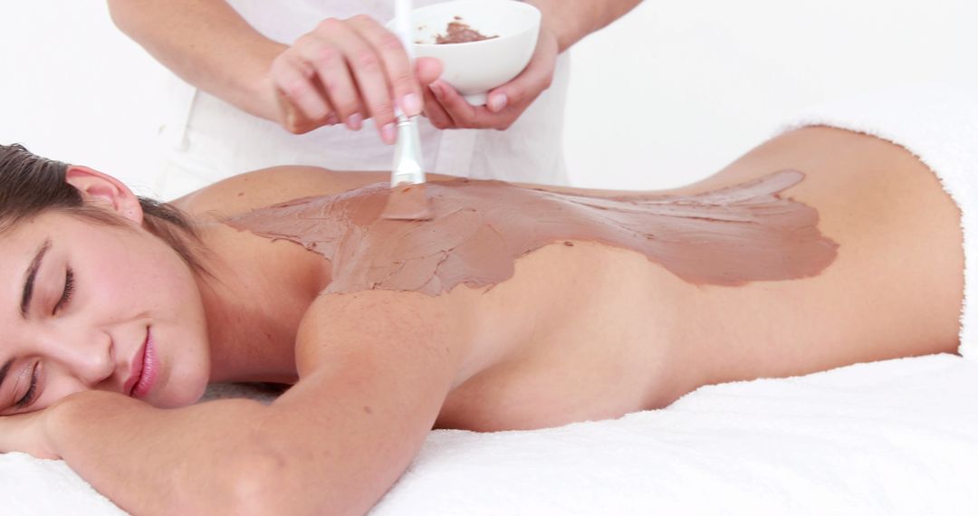 A young Caucasian woman enjoys a relaxing chocolate spa treatment, with copy space - Free Images, Stock Photos and Pictures on Pikwizard.com