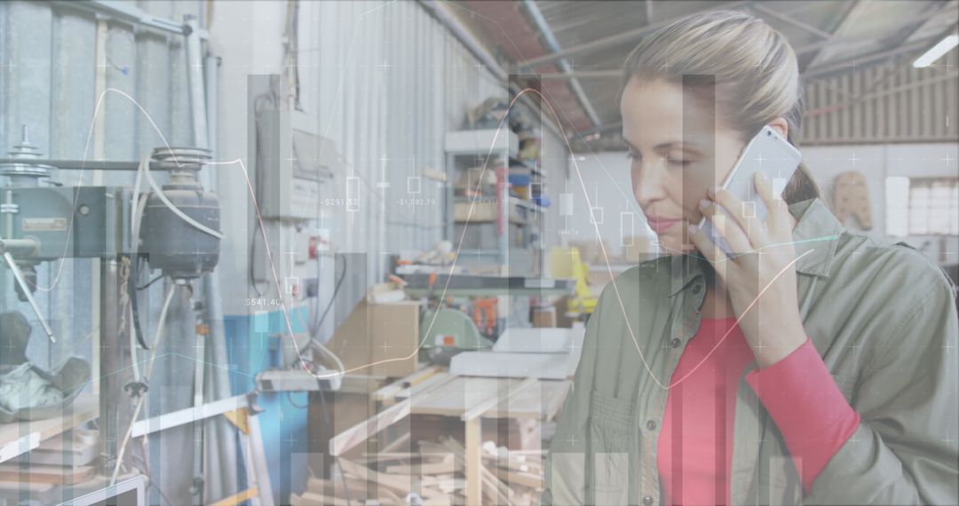 Focused Female Architect Analyzing Graphs in Workshop