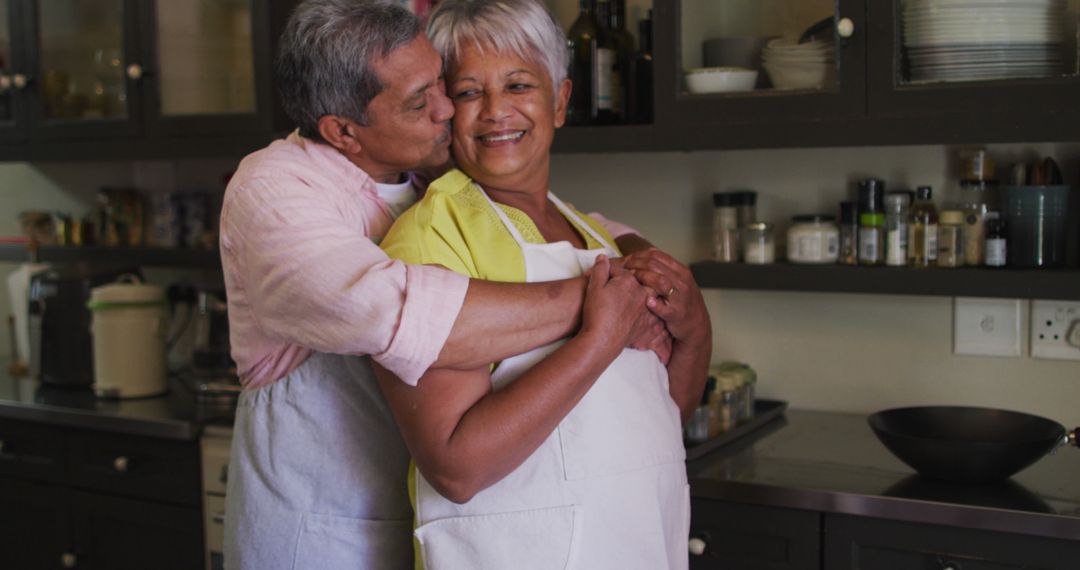 Senior Couple Embracing in Kitchen with Loving Joy