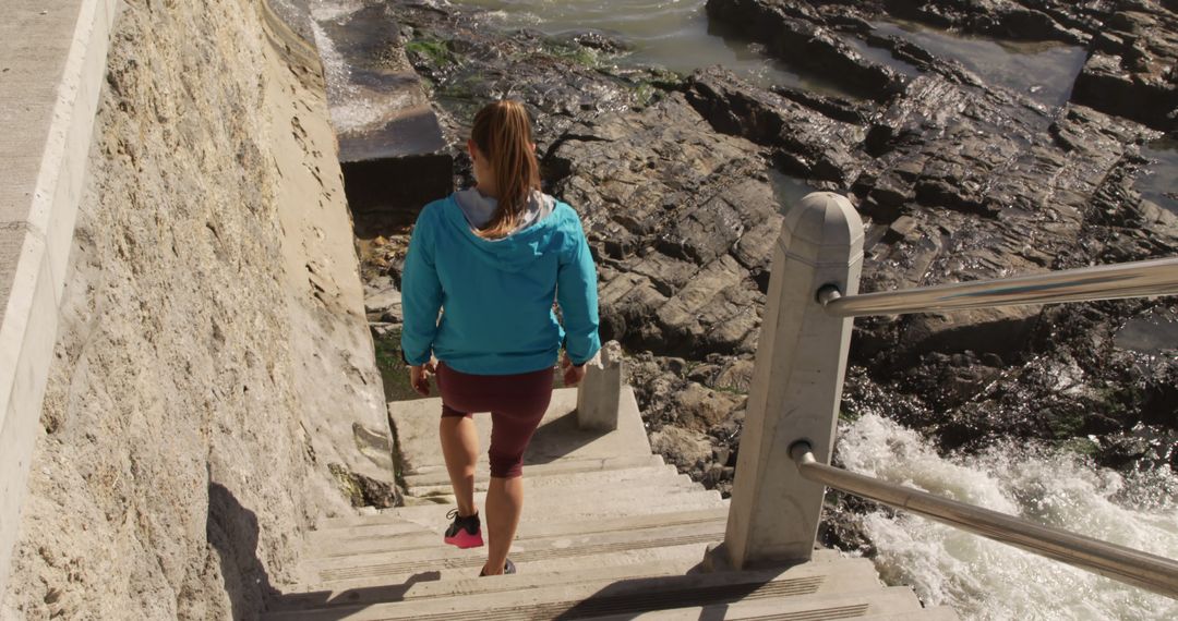 Woman Descending Steps by Rocky Seashore - Free Images, Stock Photos and Pictures on Pikwizard.com