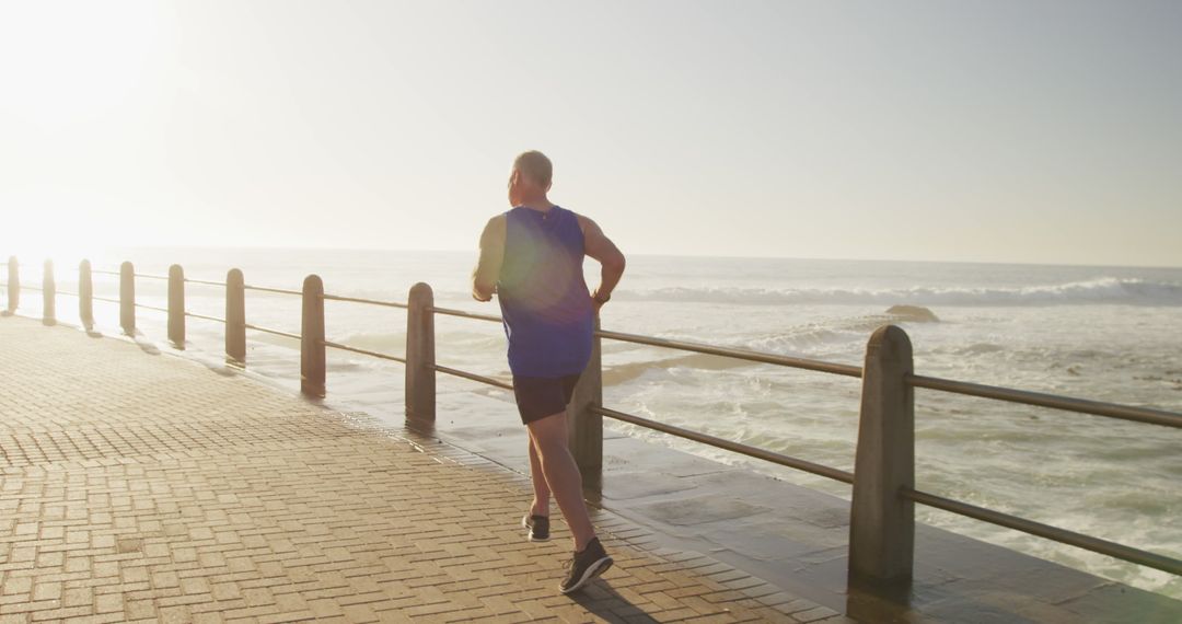 Mature Man Jogging on Coastal Pathway at Sunset - Free Images, Stock Photos and Pictures on Pikwizard.com