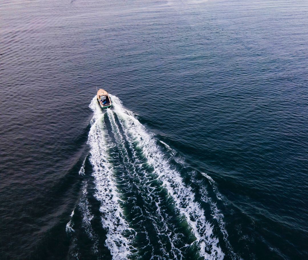 Aerial View of Boat Creating White Wake on Tranquil Ocean